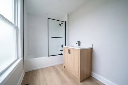 2044 S Sycamore — renovated bathroom with a tiled tub surround