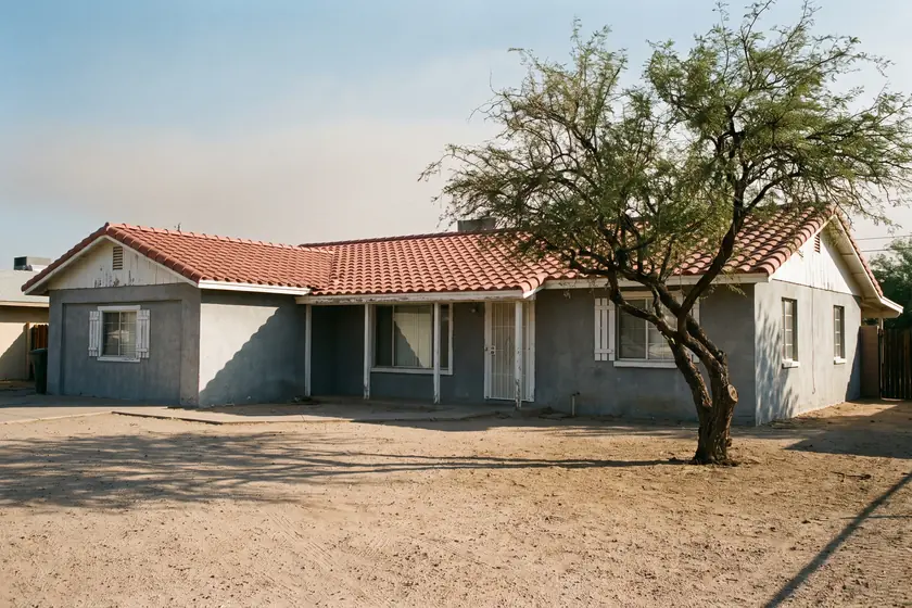 2231 N Recker Rd — painted stucco ranch elevation with a barrel-tile roof and mature mesquite